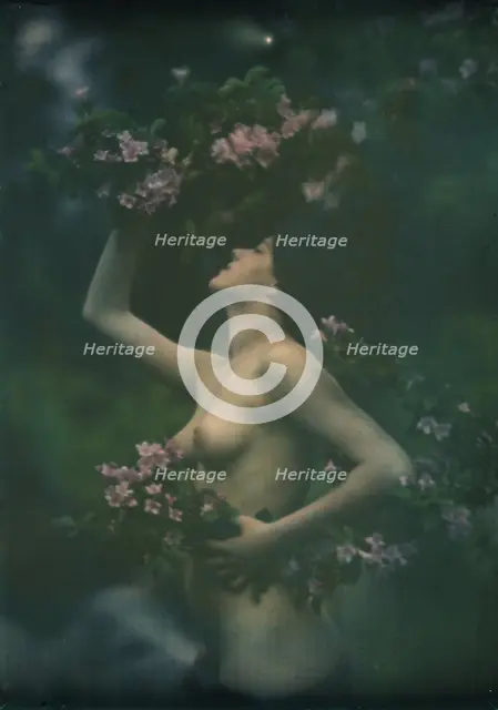 Nude woman wearing floral garlands or wreaths, between 1906 and 1942. Creator: Arnold Genthe.
