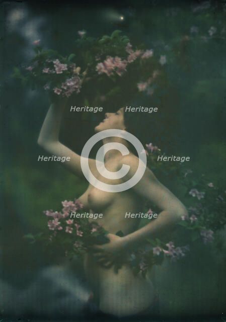 Nude woman wearing floral garlands or wreaths, between 1906 and 1942. Creator: Arnold Genthe.