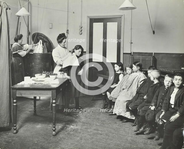 Nurse cutting children's verminous hair, Finch Street Cleansing Station, London, 1911. Artist: Unknown.