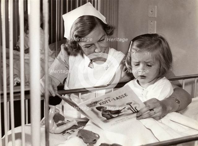 Nurse and her young patient at a children's hospital, Stockholm, Sweden, 1940s. Creator: Karl Sandels.