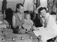 Nurse attending sick baby, FSA camp, Farmersville, Tulare County, California, 1939. Creator: Dorothea Lange