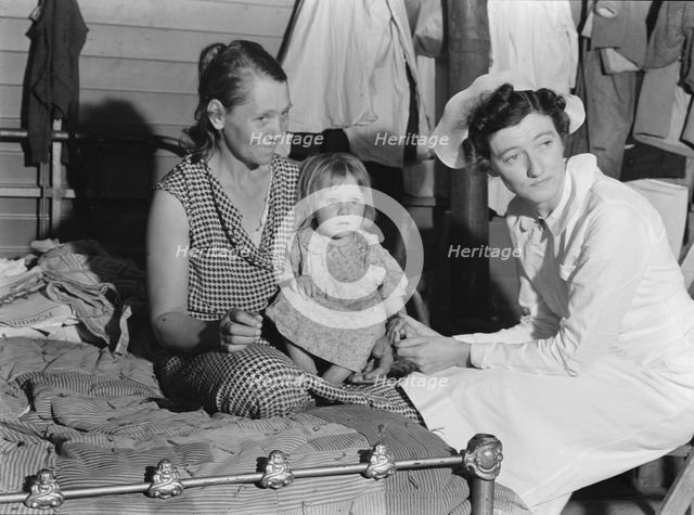 Nurse attending sick baby, FSA camp, Farmersville, Tulare County, California, 1939. Creator: Dorothea Lange.