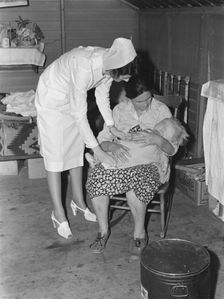 Nurse attending sick baby, FSA camp, Farmersville, Tulare County, California, 1939. Creator: Dorothea Lange