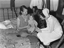 Nurse attending sick baby, FSA camp, Farmersville, Tulare County, California, 1939. Creator: Dorothea Lange