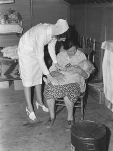 Nurse attending sick baby, FSA camp, Farmersville, Tulare County, California, 1939. Creator: Dorothea Lange