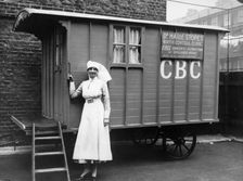 Nurse outside a Marie Stopes mobile birth control clinic, London, 1928. Creator: Unknown