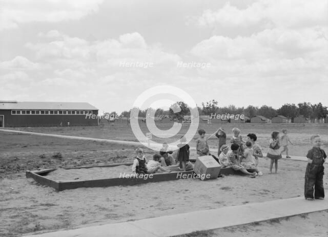 Nursery school children with their teacher, FSA camp, Tulare County, California, 1939. Creator: Dorothea Lange.