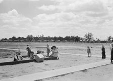 Nursery school children with their teacher, FSA camp, Tulare County, California, 1939. Creator: Dorothea Lange