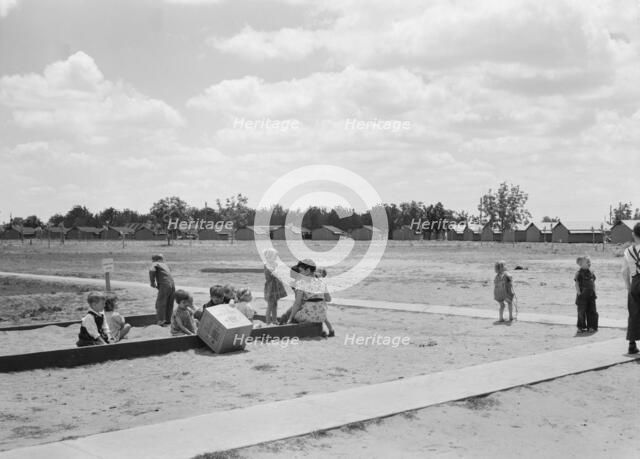 Nursery school children with their teacher, FSA camp, Tulare County, California, 1939. Creator: Dorothea Lange.