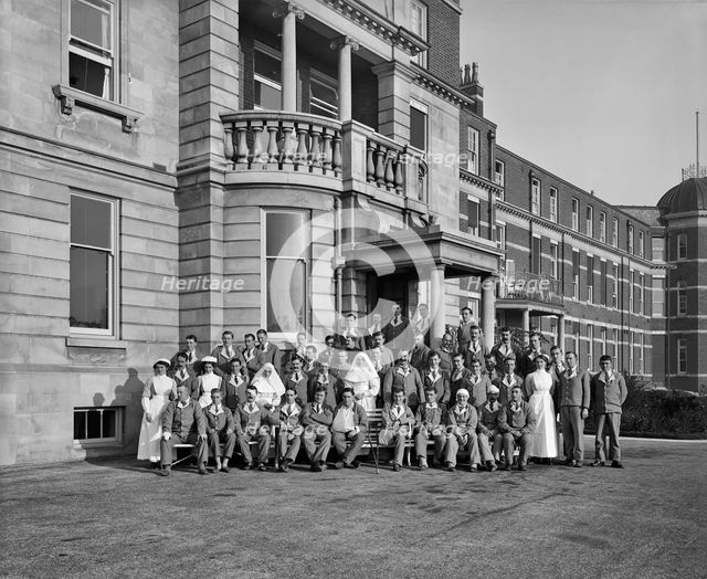 Nurses, nuns and military patients outside St Andrew's Hospital, Dollis Hill, London, October 1916. Artist: Adolph Augustus Boucher.