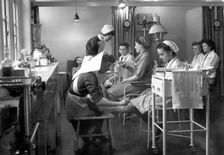 Nurses attend to staff in the Rowntree factory surgery, York, Yorkshire, 1946