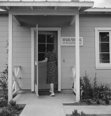 Nurse's help with sick baby, FSA camp, Farmersville, Tulare County, California, 1939. Creator: Dorothea Lange