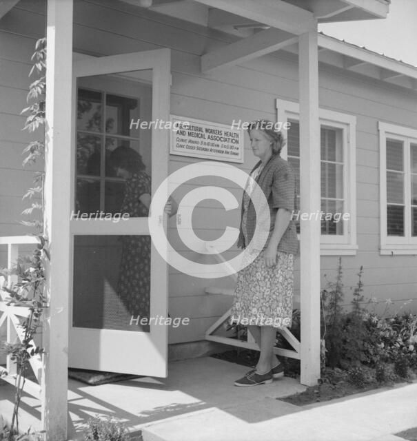 Nurse's help with sick baby, FSA camp, Farmersville, Tulare County, California, 1939. Creator: Dorothea Lange.