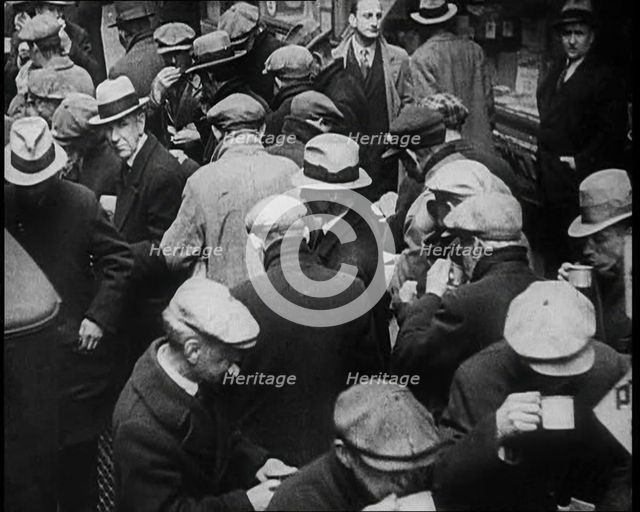 Small Crowd of Men Standing Outside in a Crowded Space, 1933. Creator: British Pathe Ltd.