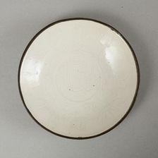 Small Ding-type bowl with incised peony scroll and dragon, 20th century