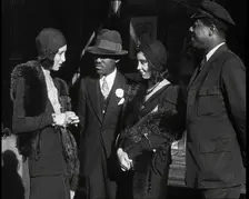 Smartly Dressed People in Conversation On the Streets of New York City, 1932. Creator: British Pathe Ltd