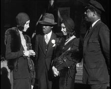 Smartly Dressed People in Conversation On the Streets of New York City, 1932. Creator: British Pathe Ltd