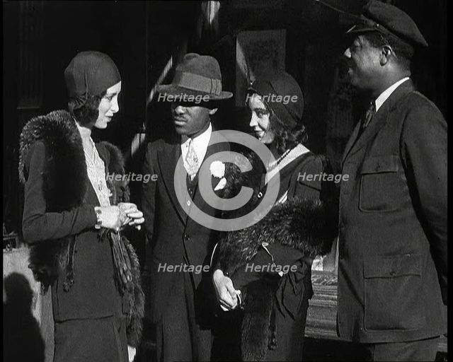 Smartly Dressed People in Conversation On the Streets of New York City, 1932. Creator: British Pathe Ltd.