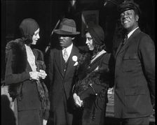 Smartly Dressed People in Conversation On the Streets of New York City, 1932. Creator: British Pathe Ltd