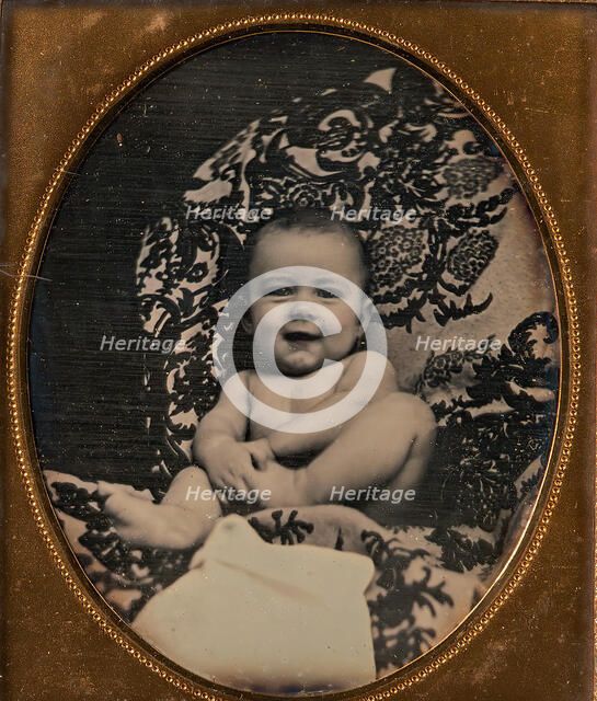 [Smiling, Nude Baby Holding Foot, Seated on Furniture Draped with Floral Print Fabric], 1850s. Creator: Unknown.