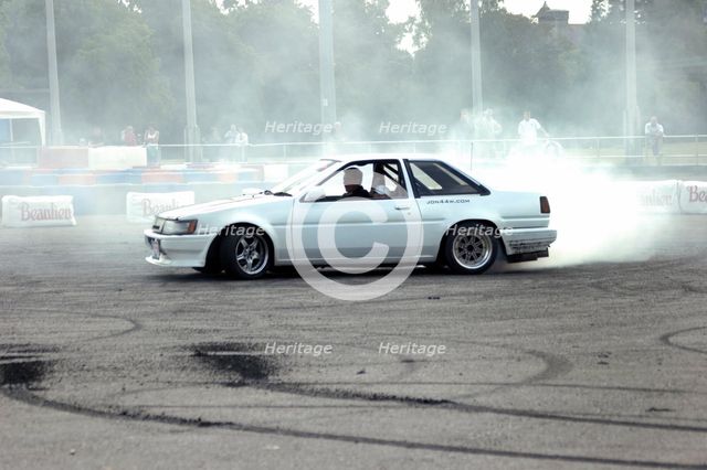 Smoking tyres during tyre burn-out. Creator: Unknown.