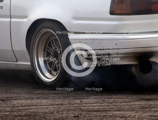 Smoking tyres during tyre burn-out. Creator: Unknown.