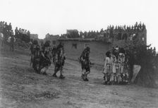 Snake dancers entering the plaza, c1905. Creator: Edward Sheriff Curtis