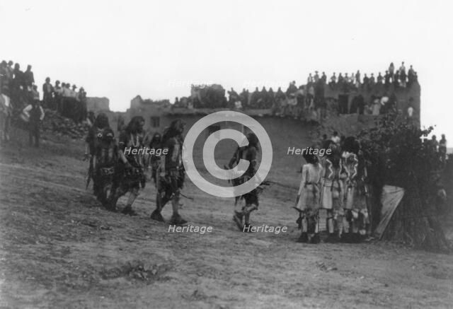 Snake dancers entering the plaza, c1905. Creator: Edward Sheriff Curtis.