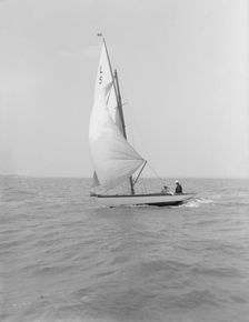 Snowdrop sailing under spinnaker, 1911. Creator: Kirk & Sons of Cowes