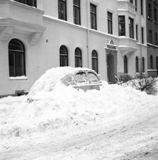 Snow in a car at telephone booth in Stockholm, Sweden, January 1954. Creator: Unknown
