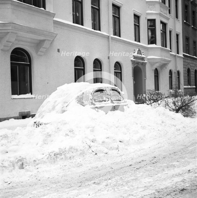 Snow in a car at telephone booth in Stockholm, Sweden, January 1954.
 Creator: Unknown.