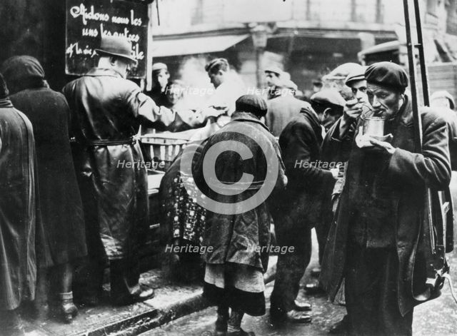 Soup kitchen for the needy, les Halles, German-occupied Paris, February 1941. Artist: Unknown