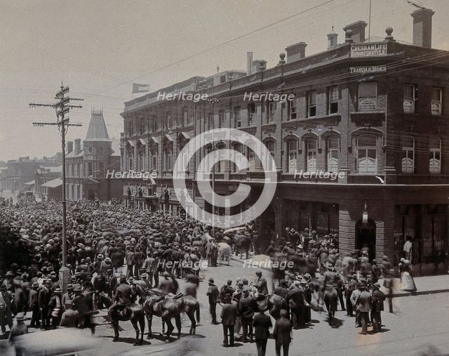 South Africa: a crowd of people gathered outside The Goldfields offices in Johannesburg, 1896. Creator: Unknown.