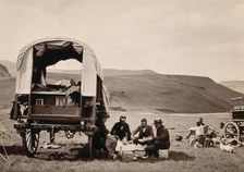 South Africa: a group of Europeans eating a meal beside their wagon in the Transvaal, c1890s. Creator: Dudley Kidd