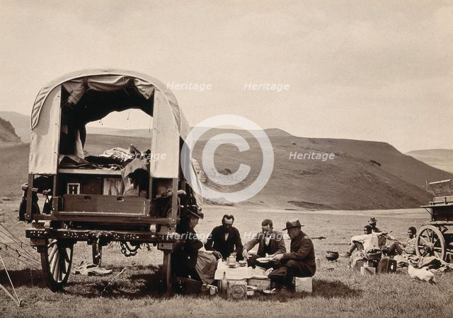 South Africa: a group of Europeans eating a meal beside their wagon in the Transvaal, c1890s. Creator: Dudley Kidd.