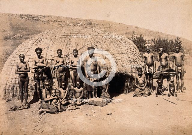 South Africa: Africans in front of a traditional kraal hut, between 1800 and 1899. Creator: Unknown.