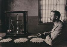 South Africa: an employee of De Beers counting the diamonds mined that day, 1896. Creator: Unknown