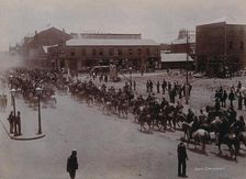 South Africa: Boer soldiers riding through a street in a South African town, 1896. Creator: Barnett