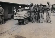 South Africa: bread carried on trolleys for the African workers at De Beers Mine, 1905. Creator: Hugh Marshall