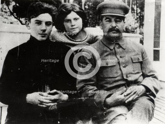 Soviet leader Josef Stalin with his son Vasily and daughter Svetlana, 1930s.  Artist: Pyotr Otsup.