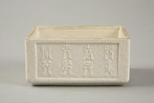 Soft paste rectangular vessel with characters in relief, early 19th century