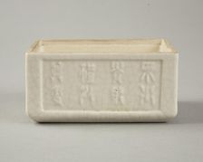 Soft paste rectangular vessel with characters in relief, early 19th century