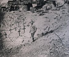 Soldier among wooden crosses, c1914-c1918