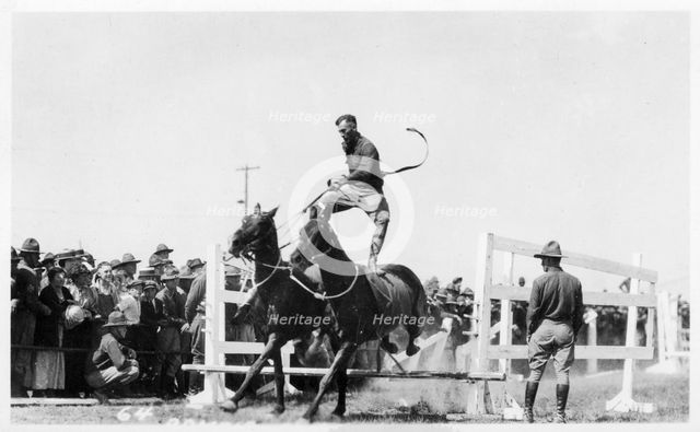 Soldier performing equestrian acrobatics, Fort Sheridan, Illinois, USA, 1940. Artist: Unknown