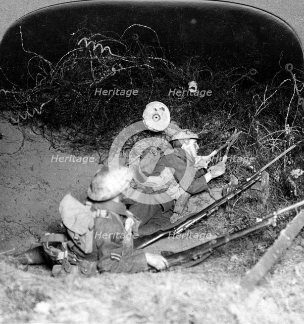 Soldiers cutting through barbed wire defences, Oppy, France, World War I, 1914-1918.Artist: Realistic Travels Publishers