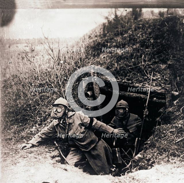 Soldiers in gas masks emerging from trenches, c1914-c1918. Artist: Unknown.