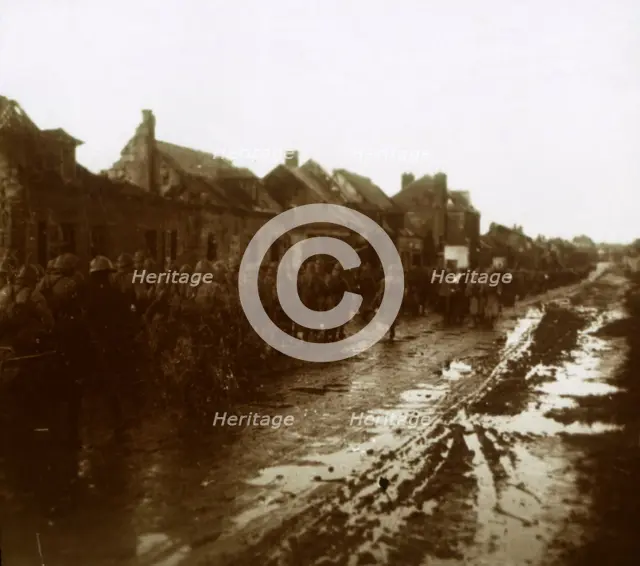 Soldiers marching past bombed-out houses, Champagne, northern France, c1914-c1918. Artist: Unknown.