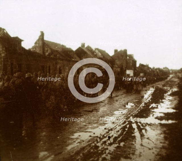 Soldiers marching past bombed-out houses, Champagne, northern France, c1914-c1918. Artist: Unknown.