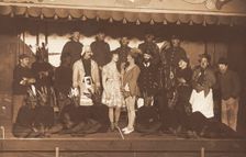 Soldiers, some in drag, pose on stage; two men in drag face each other in the centre, [1910-1919?]. Creator: Unknown