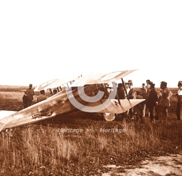 Soldiers surrounding biplane, Somme, northern France, c1914-c1918. Artist: Unknown.